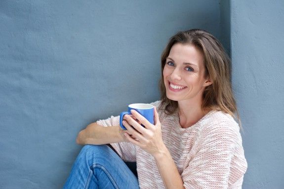 Beautiful woman enjoying a drink of a coffee