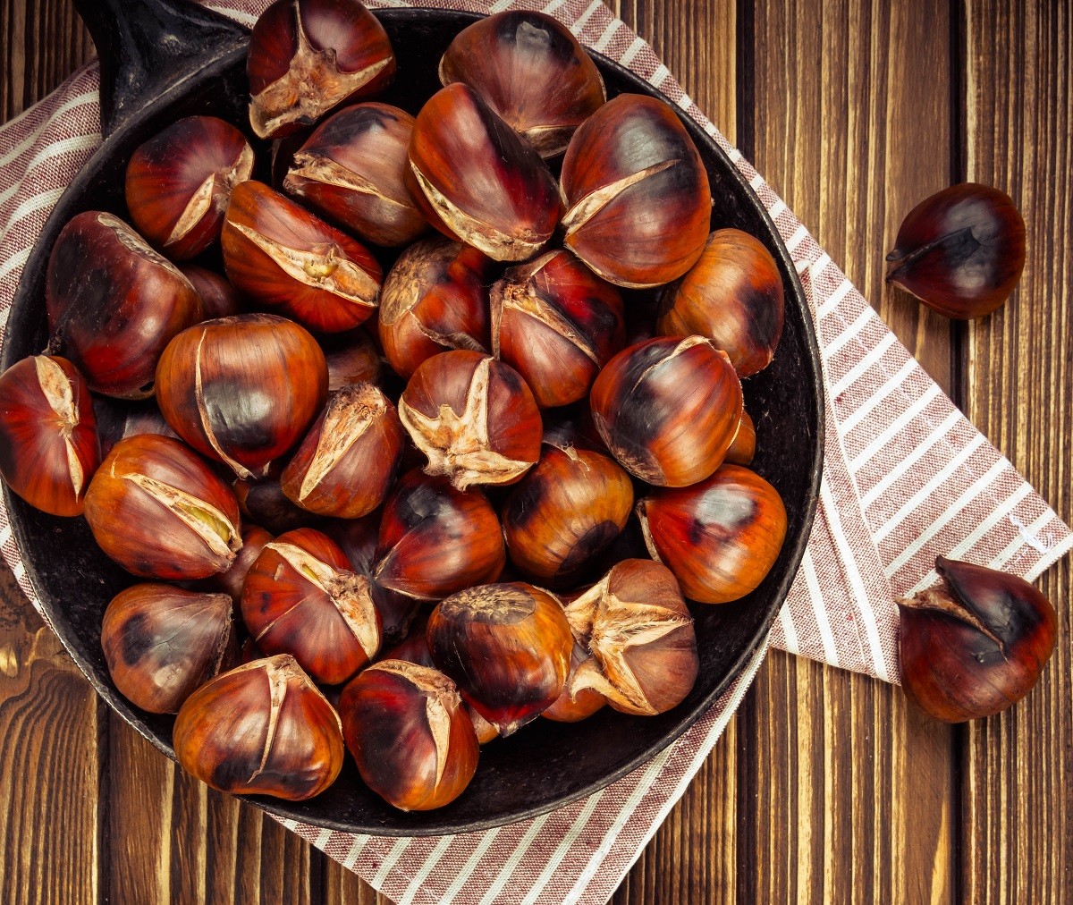 chestnuts in a pan on wooden background