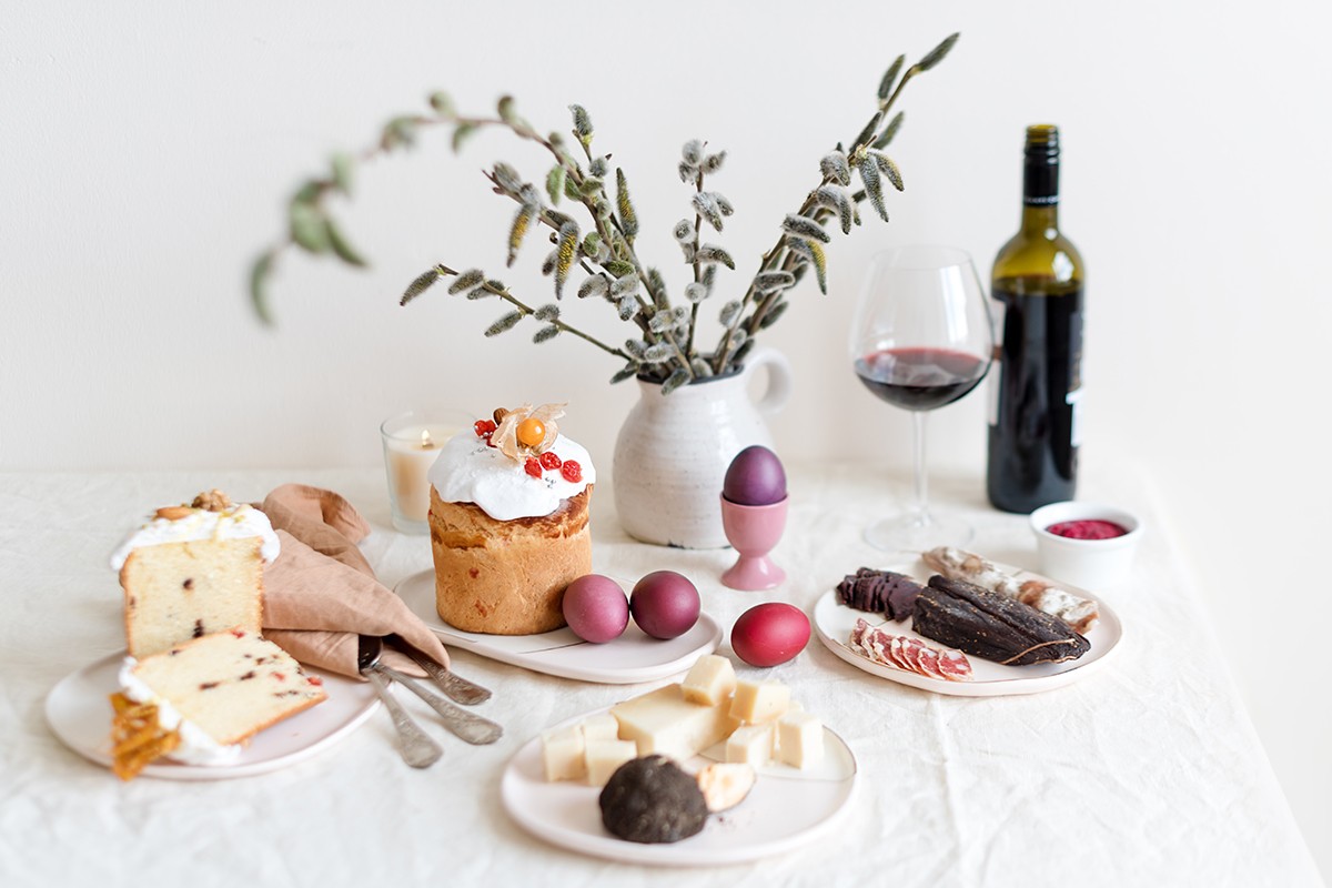 Serving Easter table with tasty dishes and glass of wine