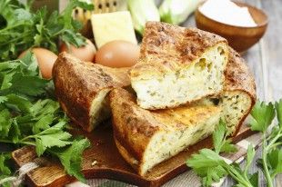 52338823 – pie with zucchini, cheese and herbs on the table