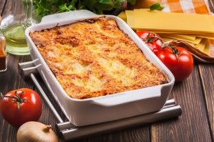 66997651 – hot tasty lasagna in ceramic casserole dish
