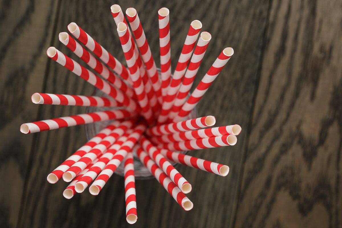 vintage paper straws in glass on wood table
