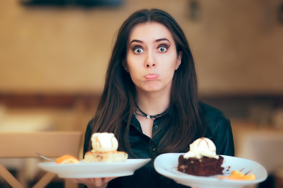 95319215 – girl trying to decide between vanilla and chocolate cake dessert