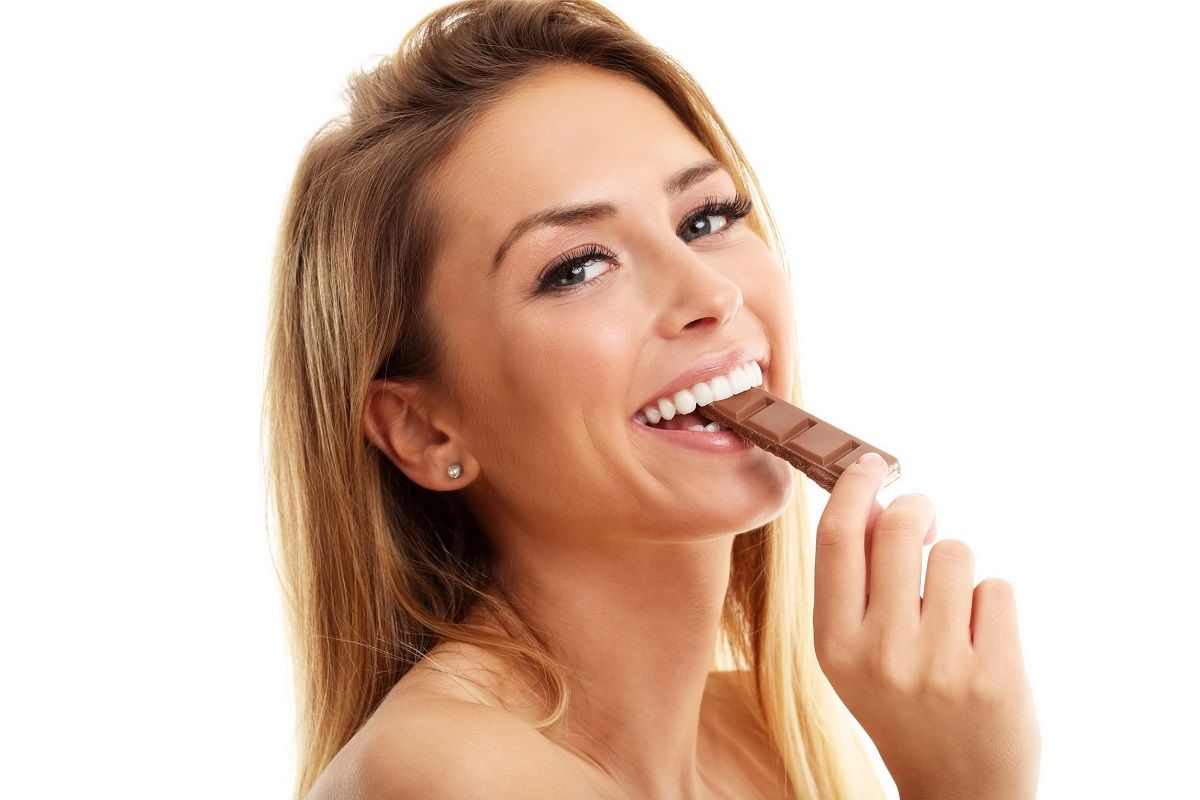 75183050 – portrait of beautiful woman holding chocolate bar