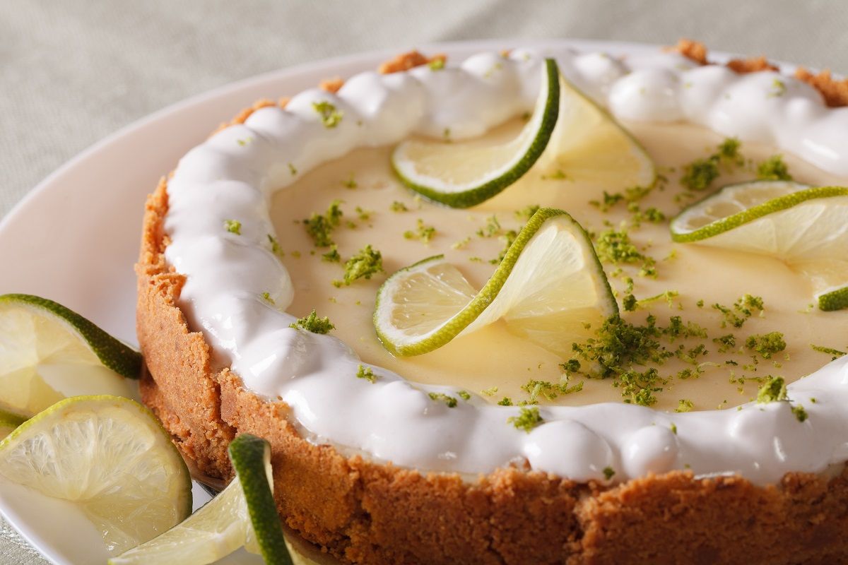 Beautiful key lime pie with whipped cream and peel close-up