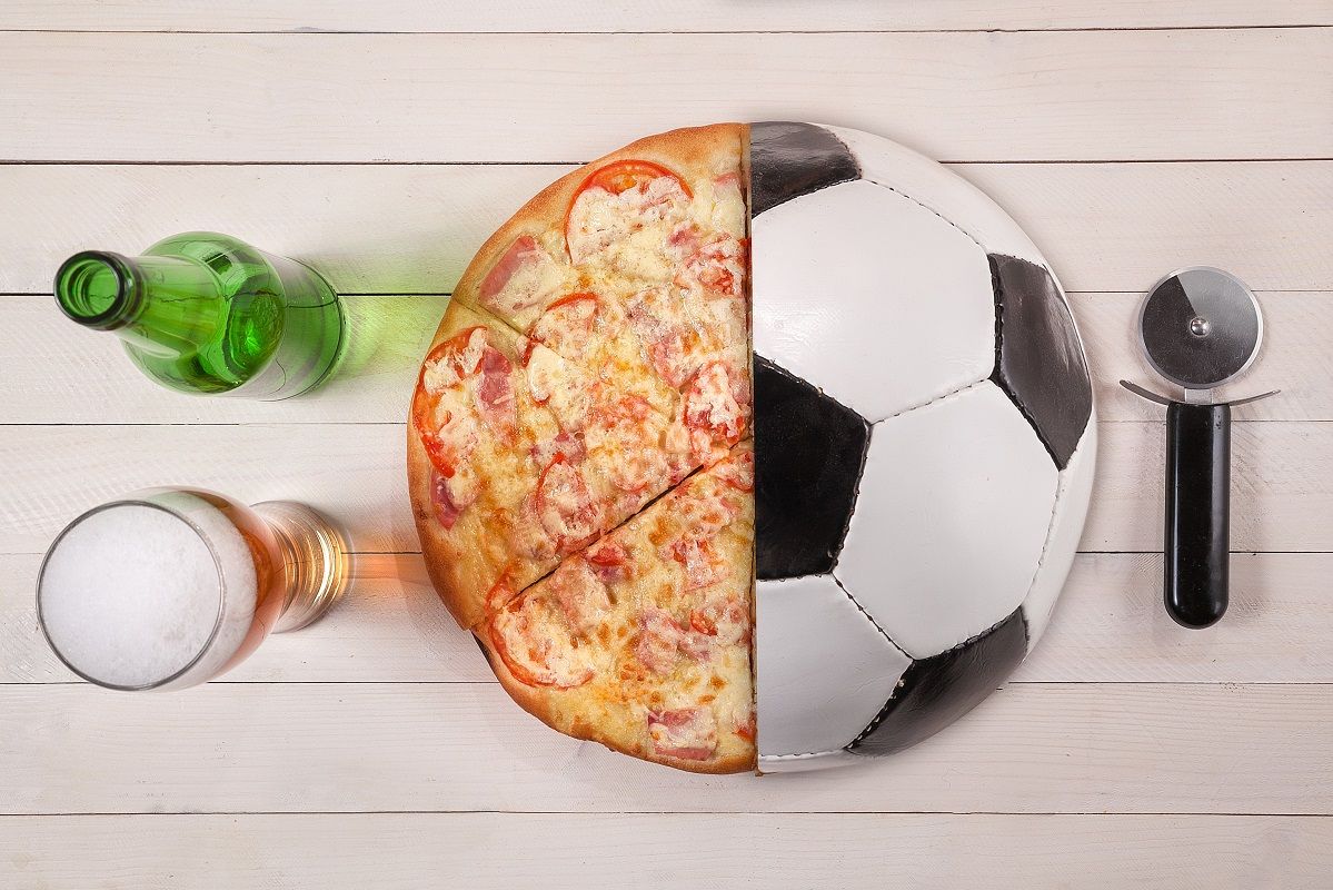 Top view of half soccer ball and pizza beer. creative con idea