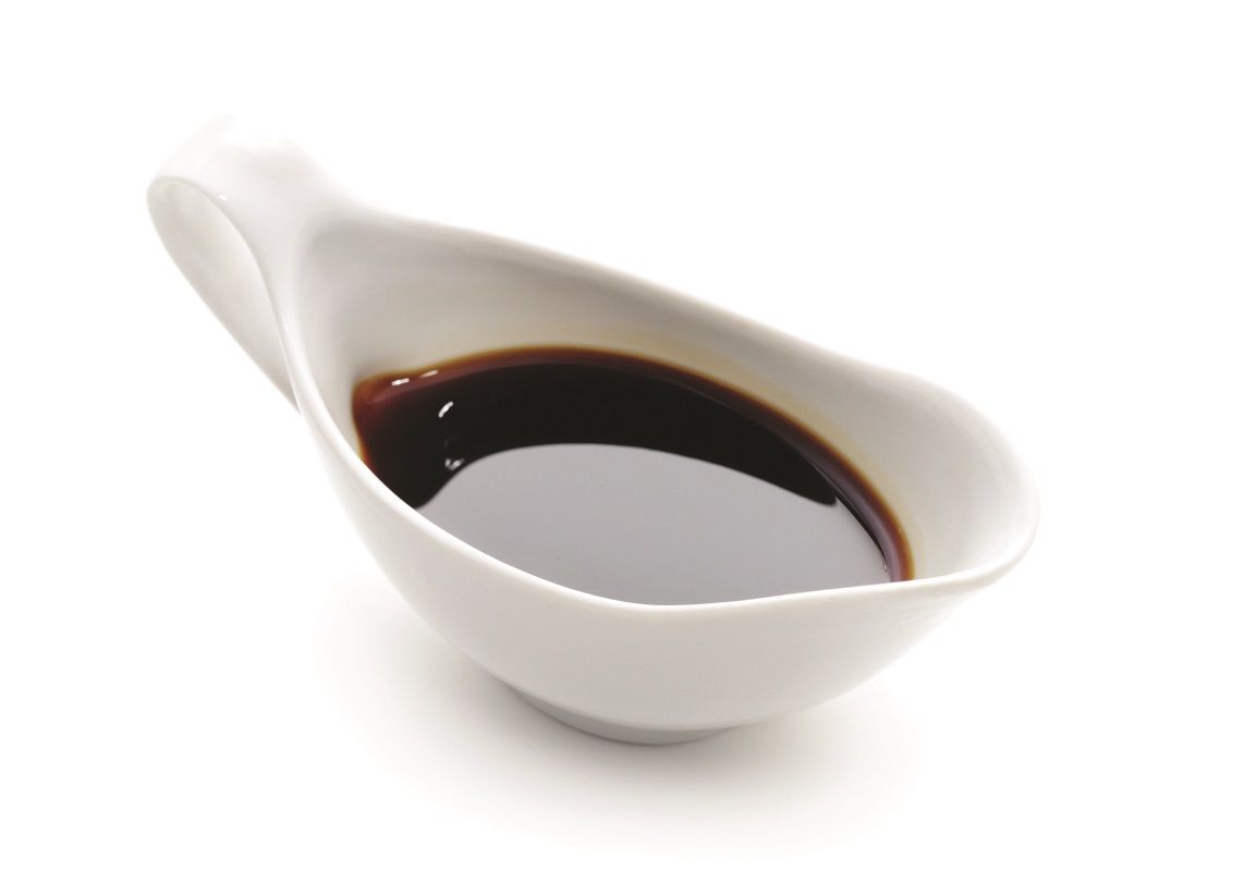 4062672 – japanese or chinese soy sauce in suace-boat. isolated over white