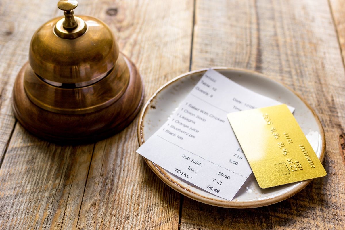restaurant bill paying by credit card and ring on wooden table background