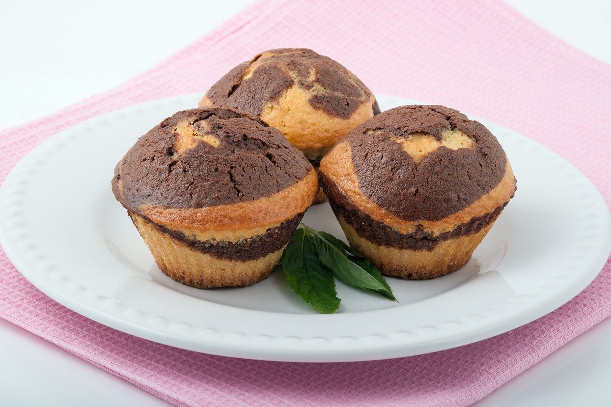 Three tasty muffins on a white plate