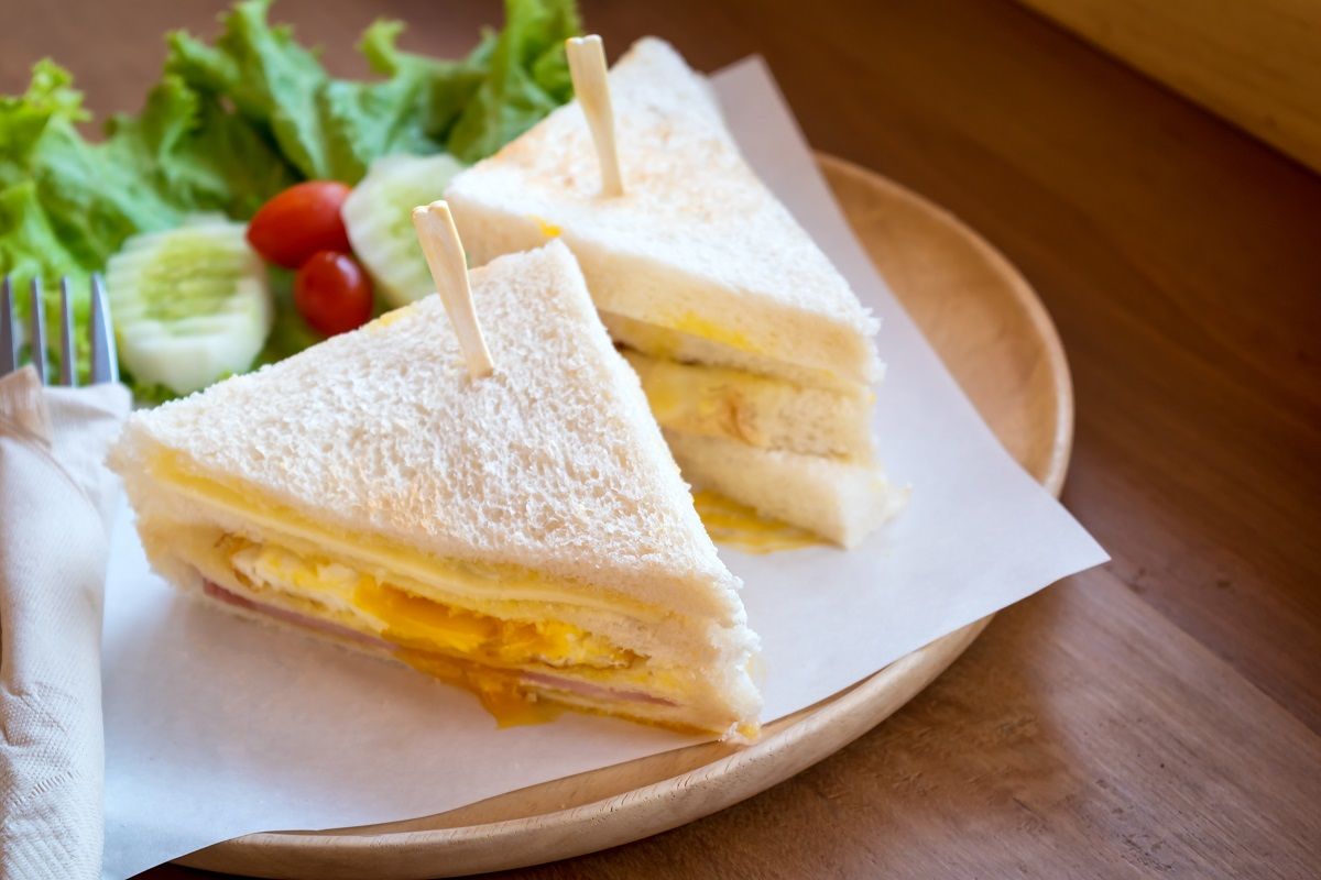 slice ham cheese egg sandwich breakfast with fresh vegetable