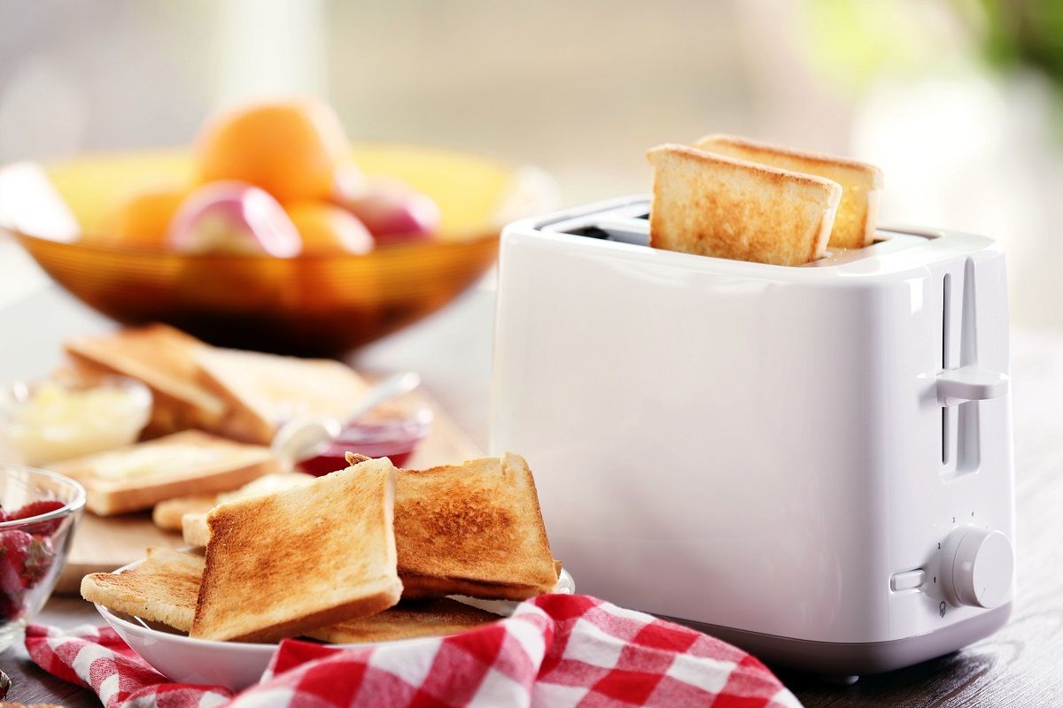 Served table for breakfast with toast and fruit, on blurred back