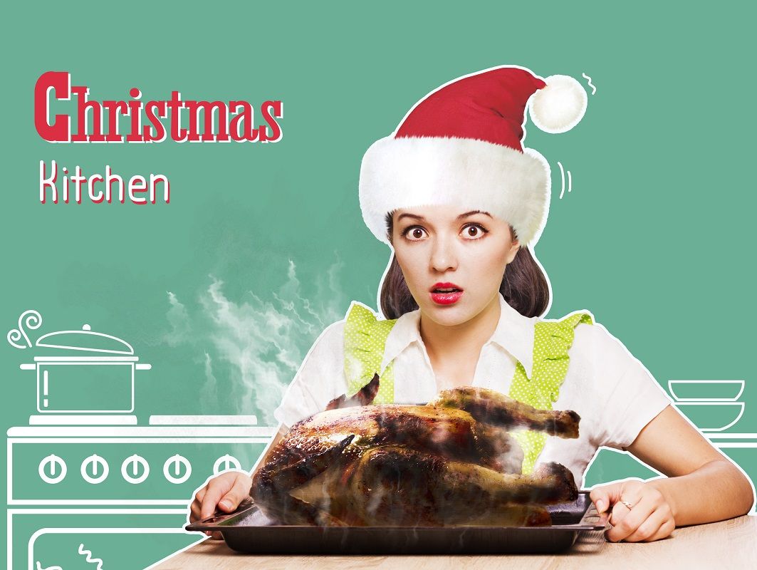 Christmas kitchen.Young woman overlooked roast chicken in her ki