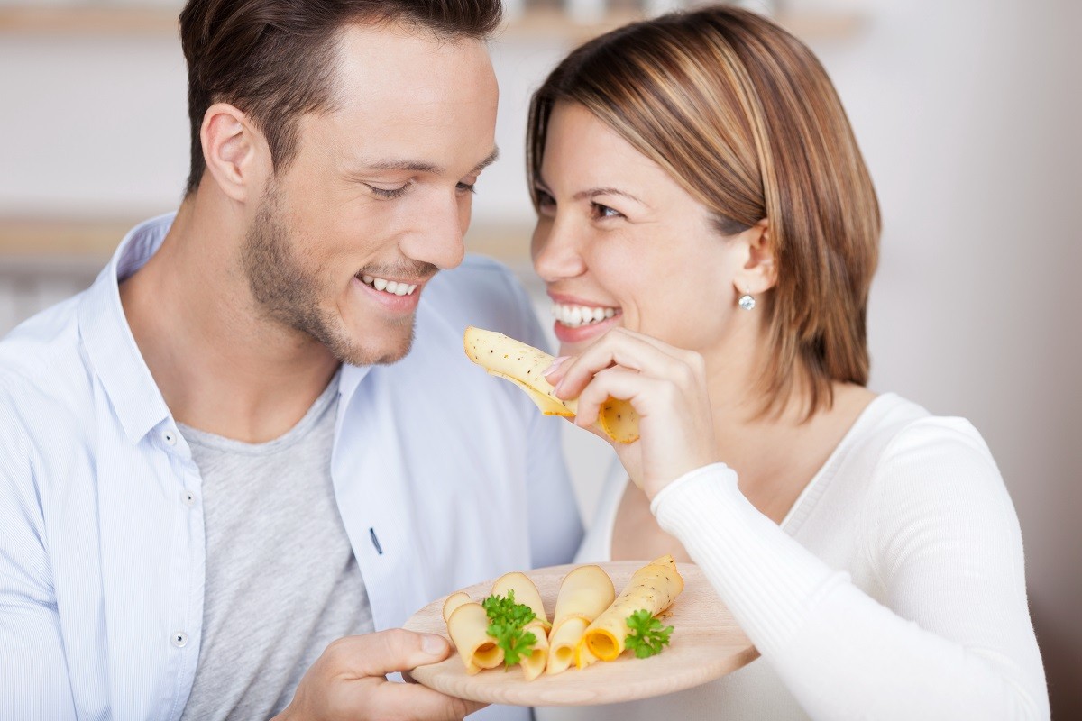 21162009 – couple eats some cheese from a variety on plate