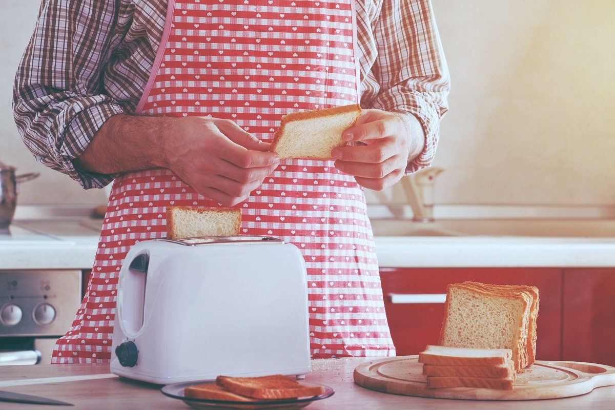 man making toasts with toaster for morning breakfast