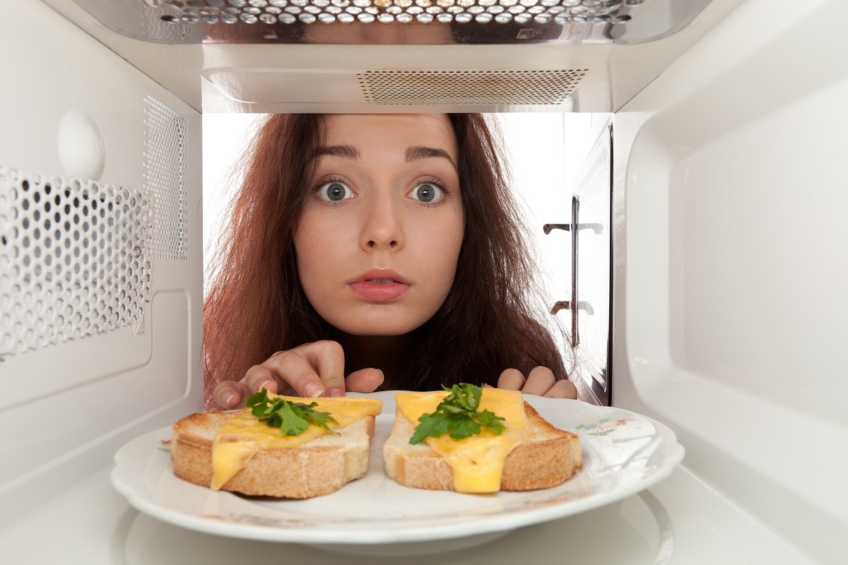 11992555 – attractive girl looks in a microwave