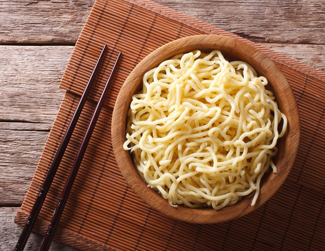 Asian ramen noodles in wooden bowl. horizontal top view