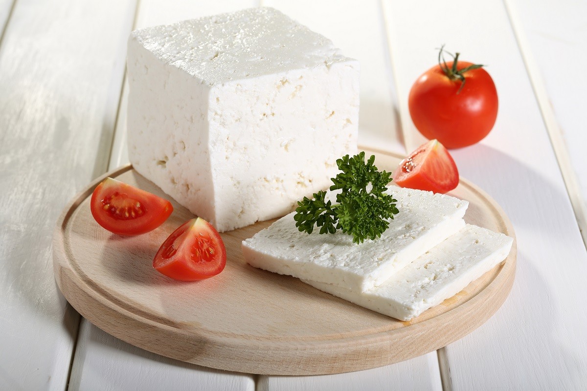 21856314 – cheese feta tomato and spices on cutting board