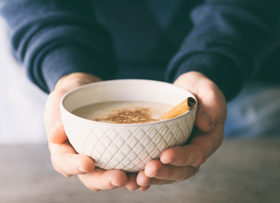 Senior man hands holding bowl with porridge