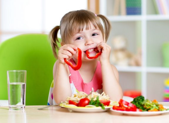 44154444 – child eating healthy food in kindergarten or at home
