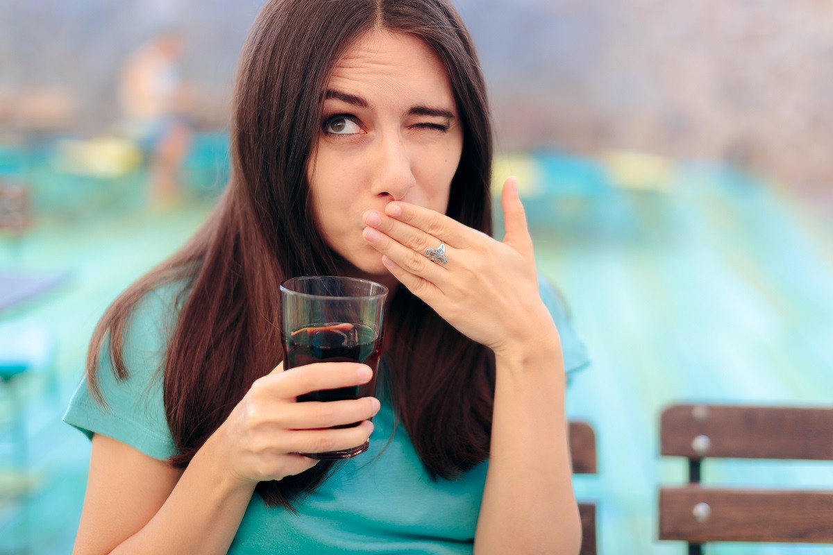 121046342 – woman reacting after having a fizzy soda drink