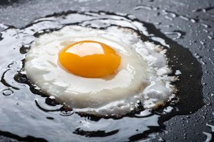 11268880 – close up view of the fried egg on a frying pan