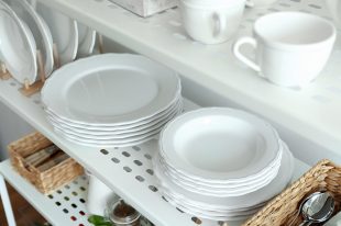 Different plates on shelf of storage stand