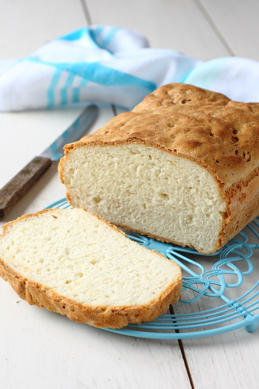Homemade gluten free bread on blue metal grid