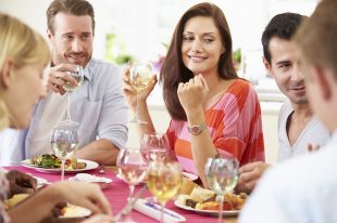 Group Of Friends Sitting Around Table Having Dinner Party