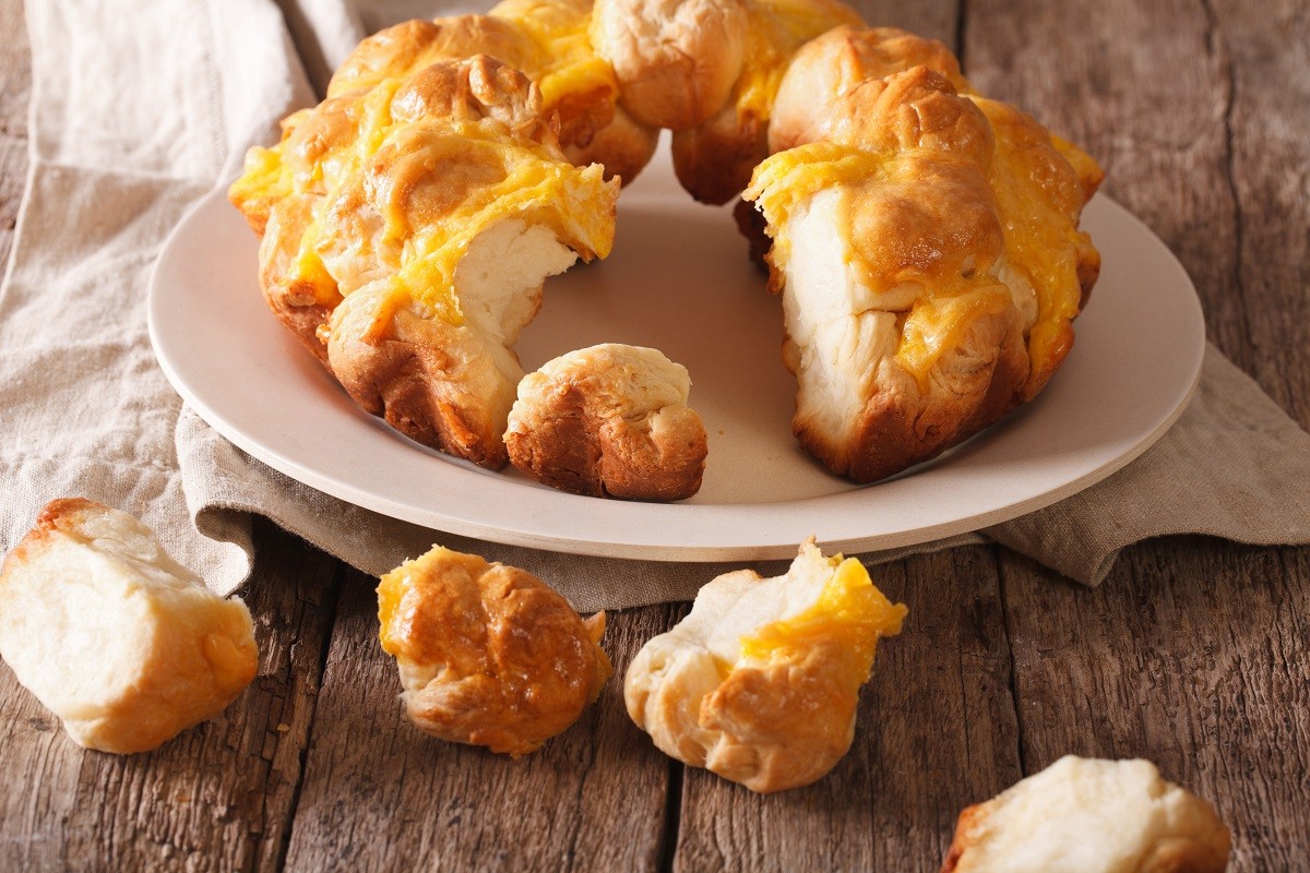 Cut monkey bread with cheese close-up on a plate. Horizontal