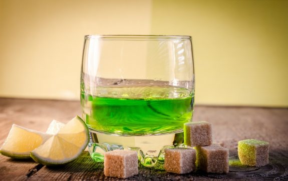 Glass of absinthe with lime and sugar cubes