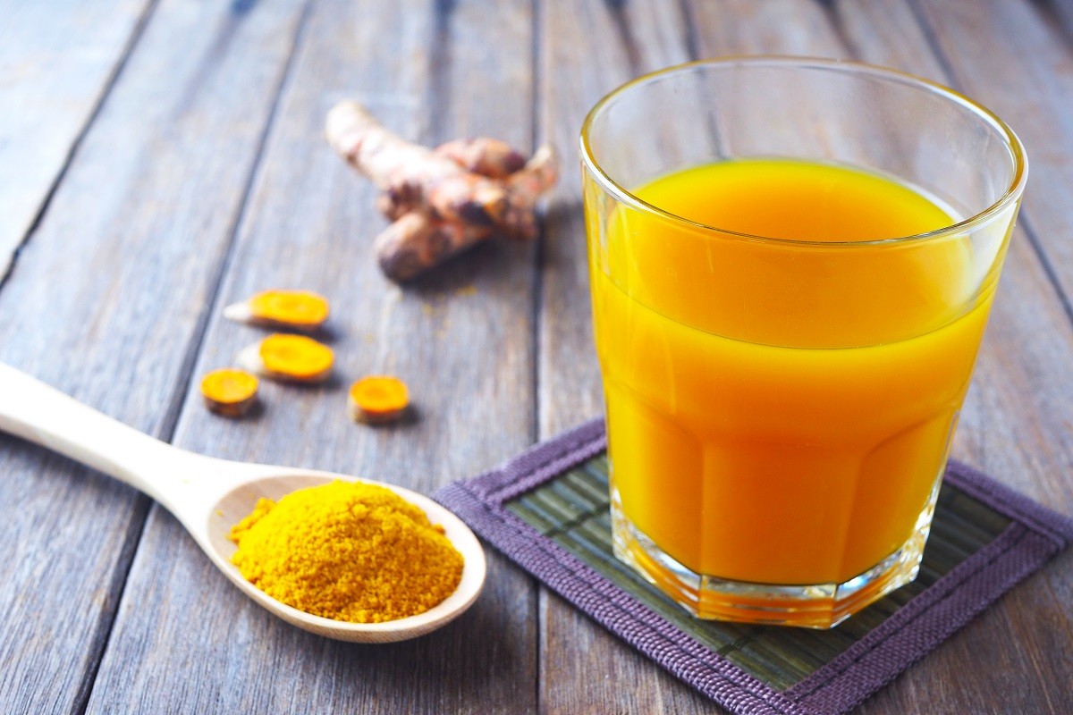 Close up of immunity boosting spicy turmeric juice and powder on