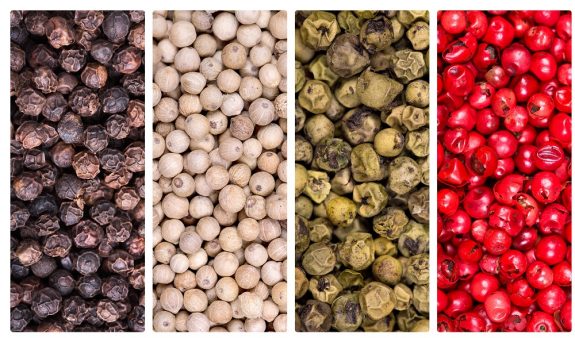 21021562 – a collage of peppercorn varieties on white