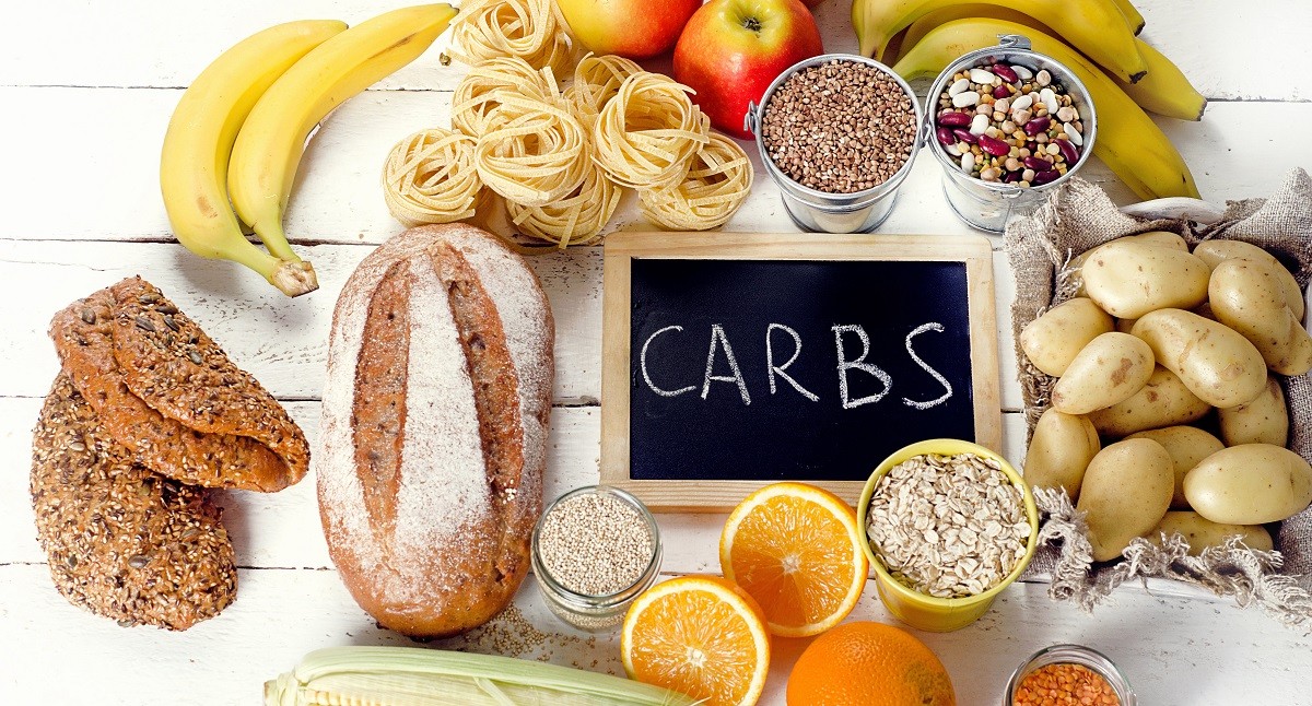 Best Sources of Carbs on a white wooden background