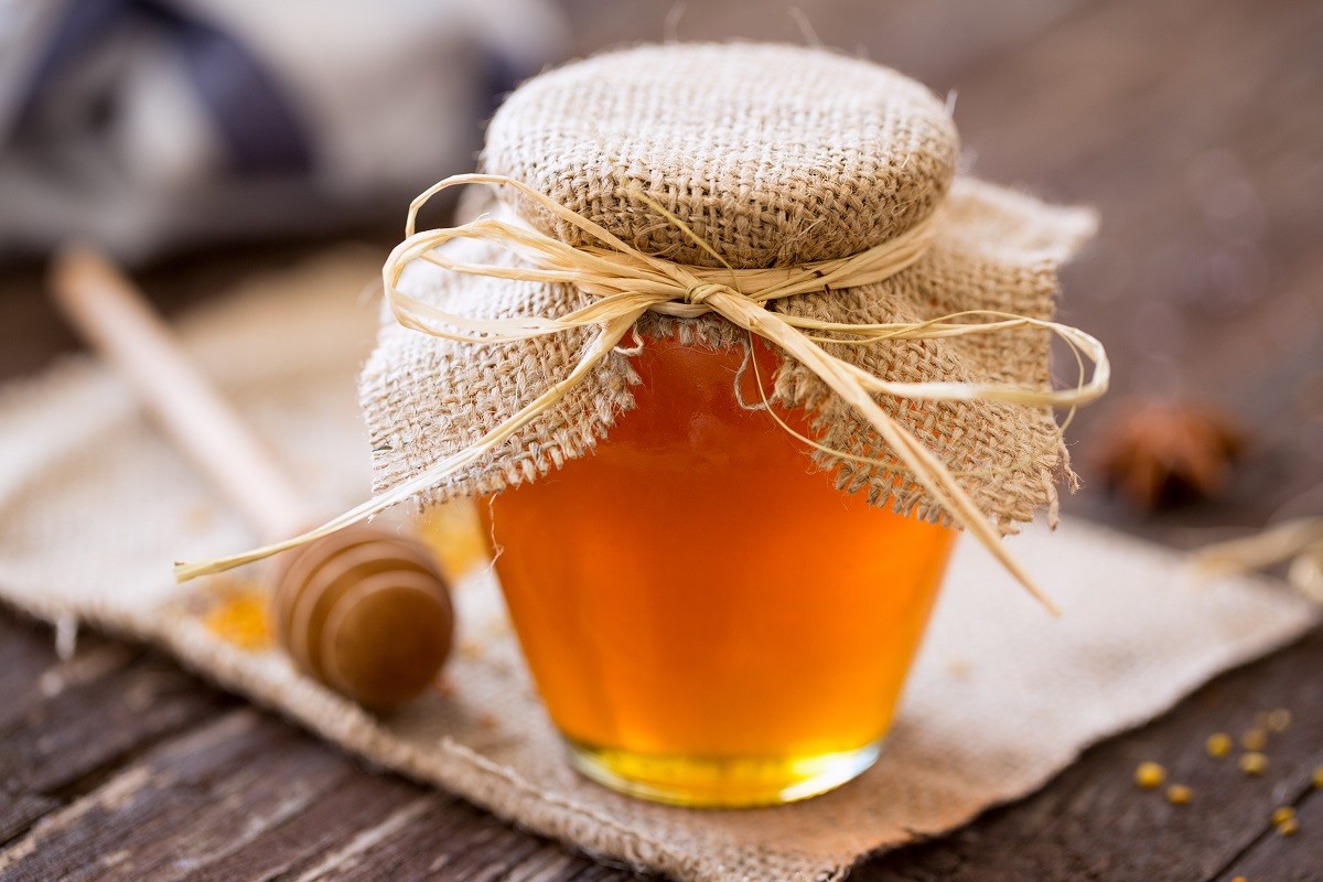 Natural honey. fresh honey in glass jar background