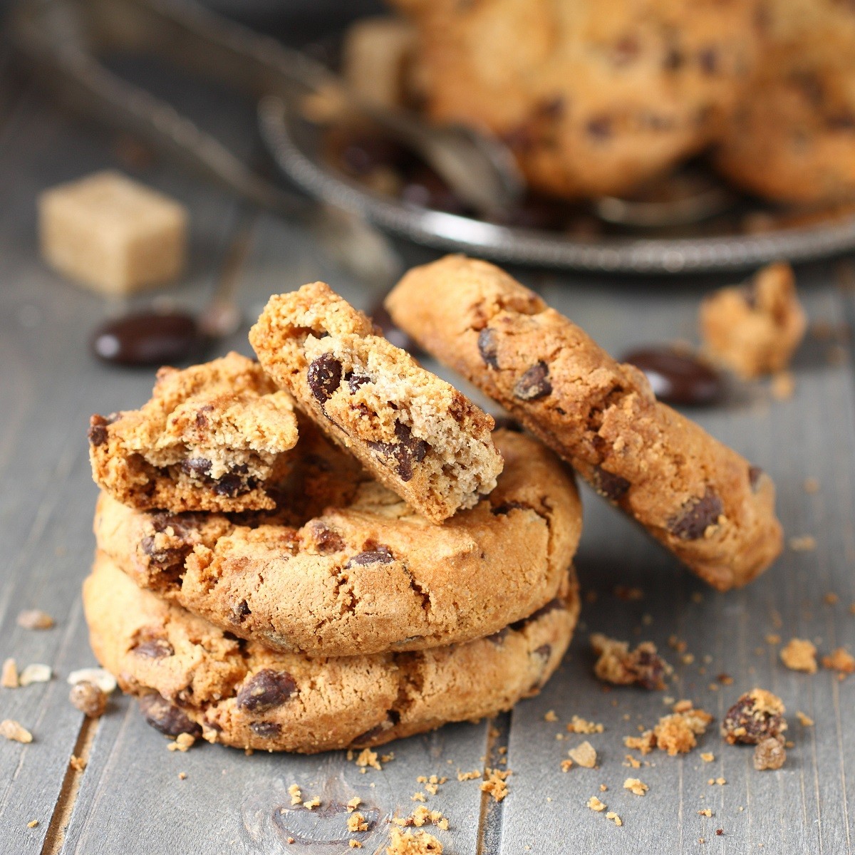 Stacked chocolate chip cookies on rustic wooden background