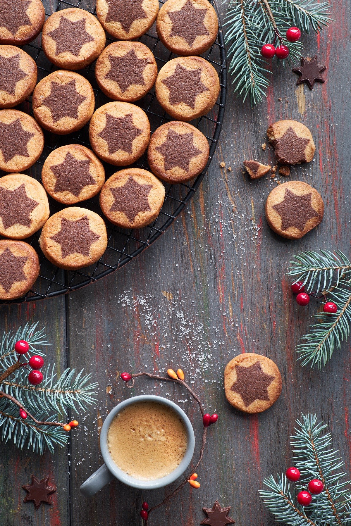 Christmas cookies with chocolate star pattern on cooling rack wi