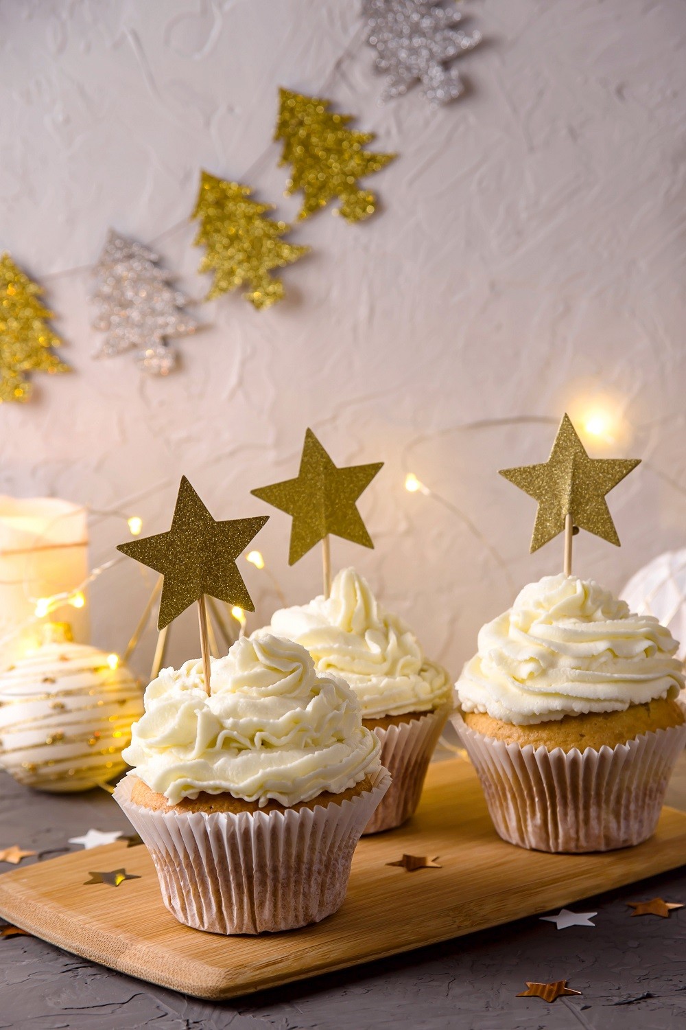 Christmas stylish dessert cupcakes with cream and golden stars