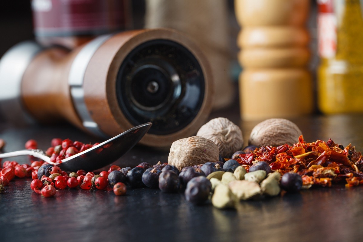 Spice and pepper grinder on slatr background