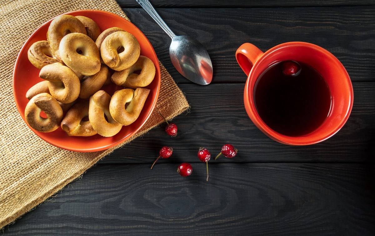 Homemade round bagels in a plate and hot rosehip tea. Idea for a