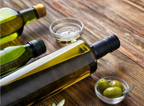 Bottles with olive oil on wooden table