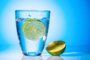 a glass of fresh drinking water and a lime  mineral water as a thirst quencher