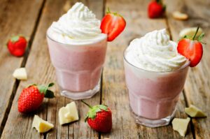 Strawberry hot white chocolate with whipped cream and strawberri
