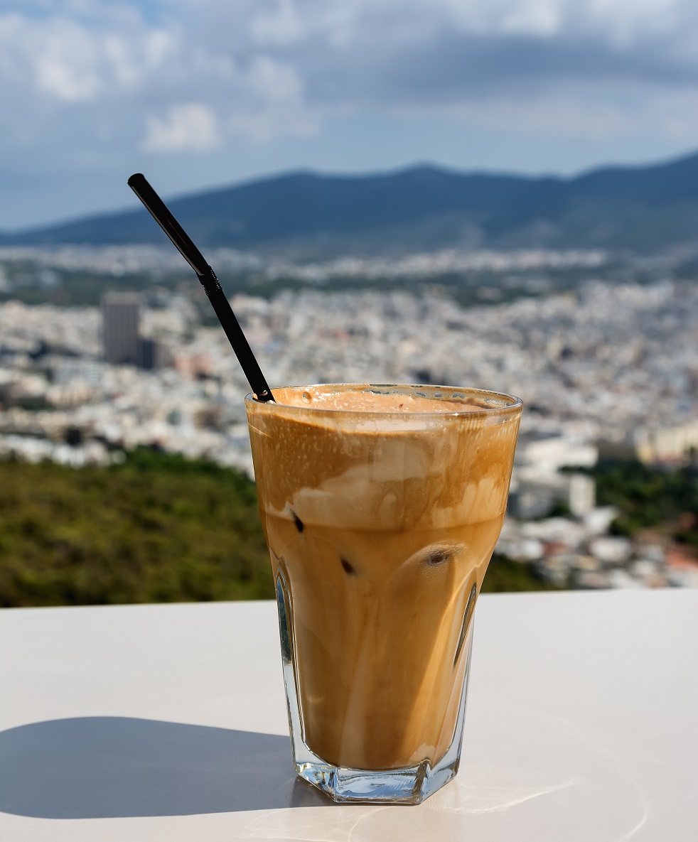 Ice frappe coffee and view of town of Athens for background