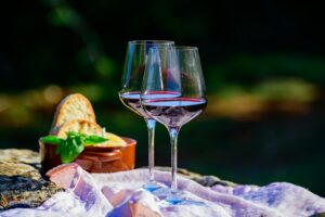 Summer picnic or outdoor tasting of red wine on vineyards in Laz