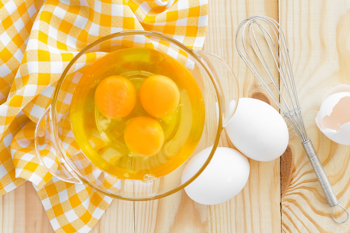 Raw eggs and whisk
