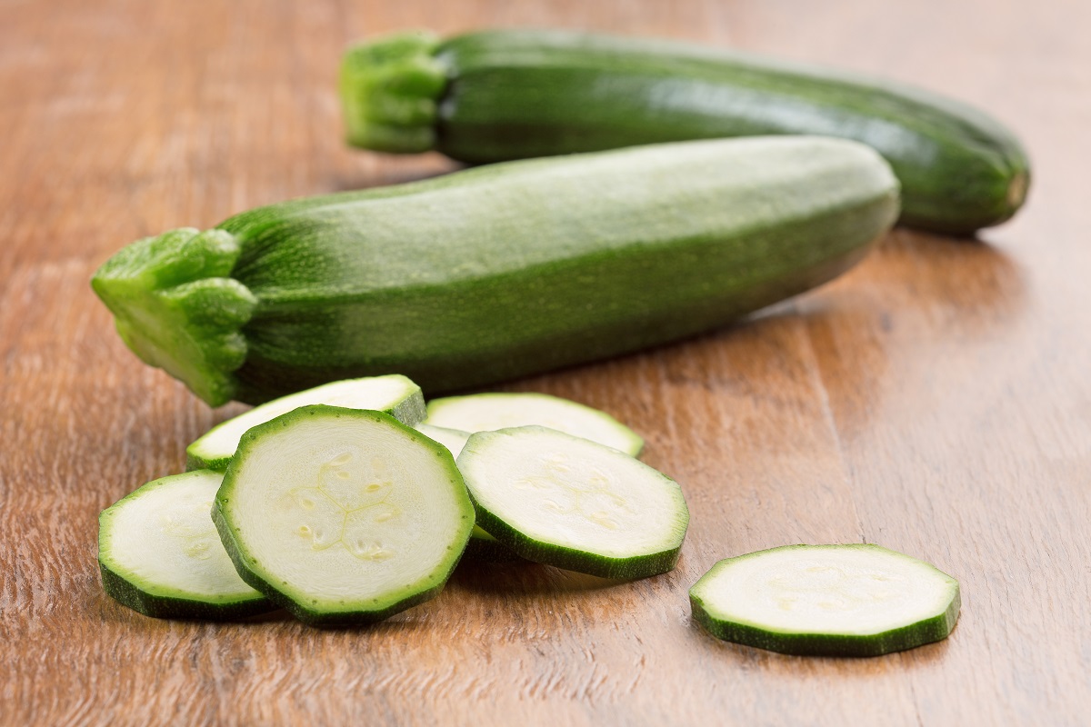 green zucchini on wooden table