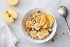 Delicious healthy breakfast. Oatmeal with banana, apple, nuts an
