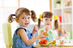 Children eating from plates in day care centre