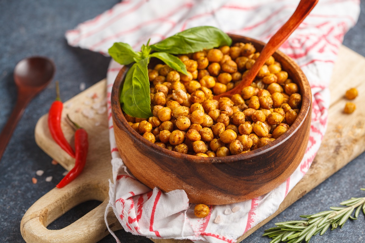 Healthy snack – baked spicy chickpeas in a wooden bowl. Healthy