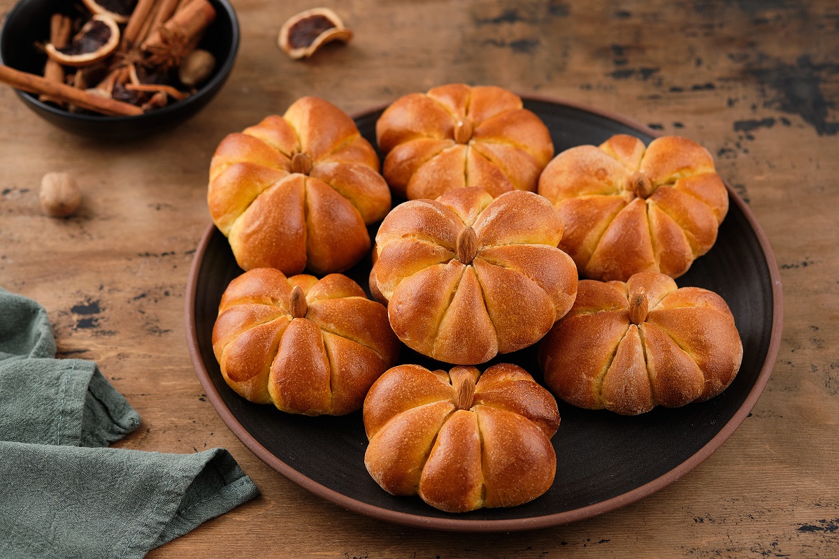 Pumpkin,Buns,Bread,With,Spices,On,Brown,Background.,Halloween,Food